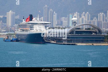 Hong Kong, China. March 14, 2024: Ocean liner Queen Mary 2 docked in Kai Tak for 2 days allowing passengers to discover Greater Bay Area megalopolis. The Cunard Line flagship is currently in Asia as part of its world tour, arriving from Australia/Indonesia, leaving today for Vietnam/Singapore. Following Red Sea tensions & Houthi missile attacks threats on ships transiting the region, the cruise ship, initially scheduled to pass through Suez Canal & Mediterranean, was forced to change its route and will bypass Horn of Africa to reach Southampton on April 28. Credit: Kevin Izorce/Alamy Live News Stock Photo