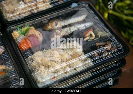 Bento is a ready-to-go portion of food, quite common in Japanese cuisine. Traditionally it usually includes rice, fish or meat, and a vegetable-based Stock Photo