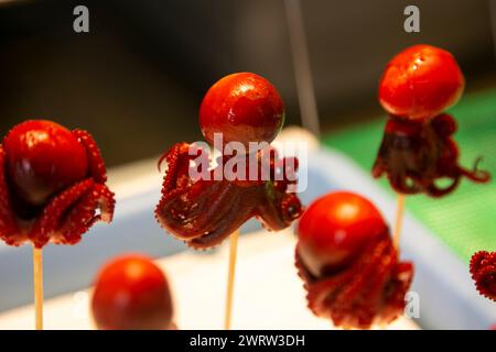 Tiny octopus with boiled quail egg inside in a market stall in Nishiki fish market in Kyoto, Japan. Stock Photo