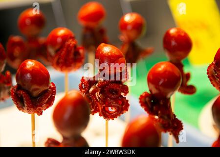 Tiny octopus with boiled quail egg inside in a market stall in Nishiki fish market in Kyoto, Japan. Stock Photo