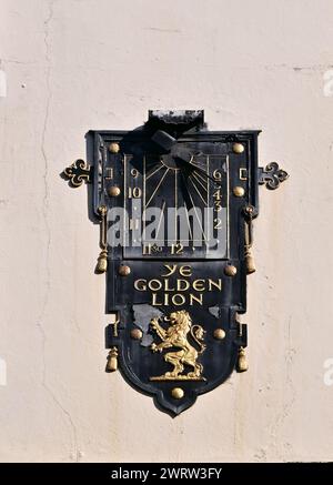 Sundial and 'Ye Golden Lion' pub sign on the wall in Dean Street, Soho, London, England, UK . Stock Photo