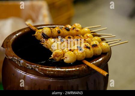 Grilled Sticky Rice Ball in street kiosk. Traditional Japanese food Mochi Stock Photo