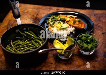 A rustic table set with plates, bowls, and cutlery Stock Photo