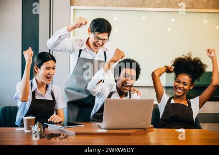 Diverse entrepreneurs in stylish coffee shop have a team meeting. Barista owner discuss work on Stock Photo