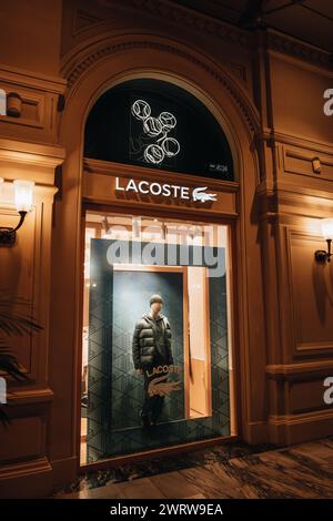 Facade and logotype of Lacoste brand retail shop singboard on the storefront in the shopping mall Stock Photo