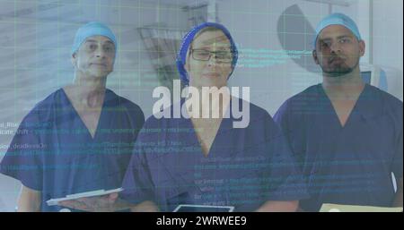 Image of computer language and infographic interface over diverse doctors standing in hospital Stock Photo