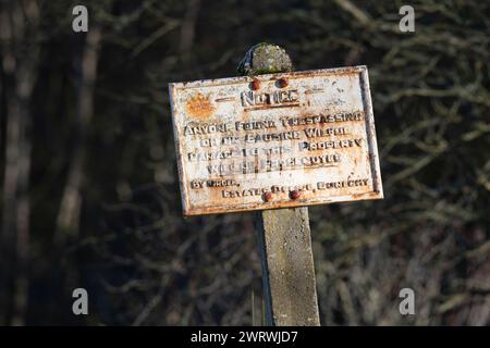 An Rusty, Old Fashioned Warning Sign on Dunecht Estate Advising That Anyone Trespassing or Causing Wilful Damage Will Be Prosecuted Stock Photo