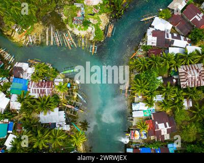 Blue clear water over the Bogac Cold Spring surrounded by villlages and ...