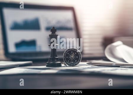 The King in chess pieces, compass and pen are placed on financial documents to signify being the best in business. Abstract  business concept. Stock Photo