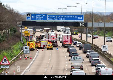 A road traffic accident on the approach to Junction 10, Wisley on the M25 motorway with emergency services in attendance Surrey England UK Stock Photo