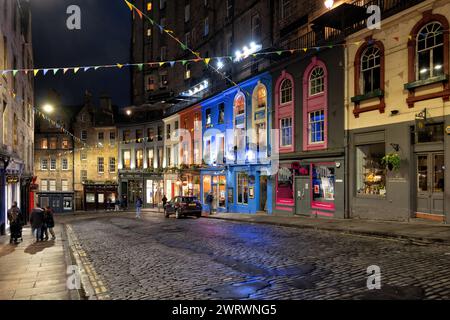 Edinburgh, Scotland, UK - May 8, 2023: Victoria Street at night, cobbled road in the Old Town with colorful buildings and retail stores, city landmark Stock Photo