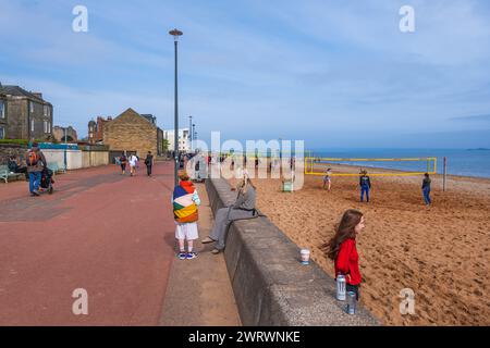 Edinburgh, Scotland, UK - May 13, 2023: Portobello promenade and beach with people playing volleyball, lively coastal suburb east of the city center. Stock Photo