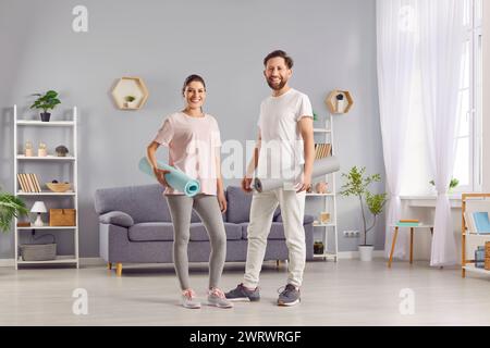 Smiling Athlete Couple Taking A Break At Home Stock Photo