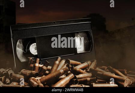 Photo of an old video tape cassette on pile of bullets. Ruined city wasteland background. Stock Photo