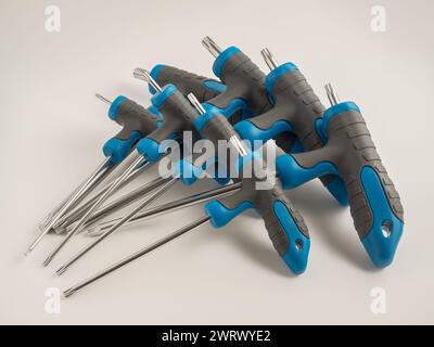 Close up of a set of handled Torx hex screw drivers tools isolated on a white background Stock Photo