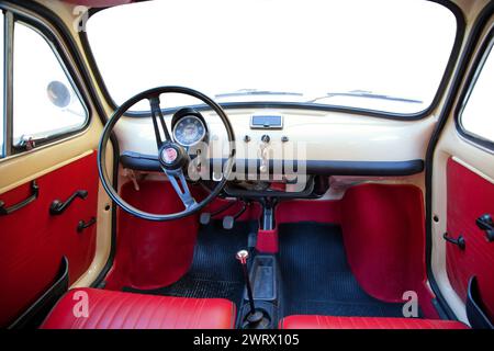 Florence, Italy - January 12, 2012: Vintage Fiat 500 was one of the most produced European. Interior view with customizable windshield and side windows. Stock Photo