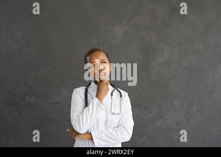 Serious African American woman doctor think make decision Stock Photo