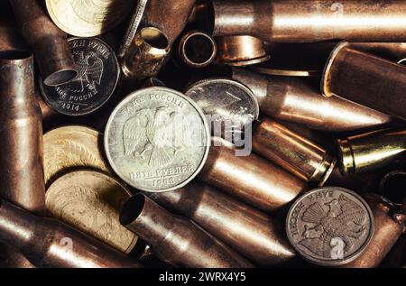 Photo of russian coins laying on bullet shells, close up view. Stock Photo