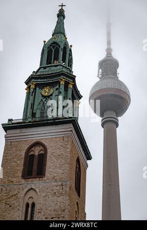 Alexanderplatz is a large public square and transport hub in the central Mitte district of Berlin. Marienkirche at the Square. Stock Photo