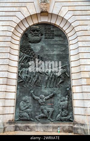 Berlin, Germany - December 16, 2021: Bas relief depiction of Karl Marx and the socialist idea on a wall in Berlin, Germany. Stock Photo