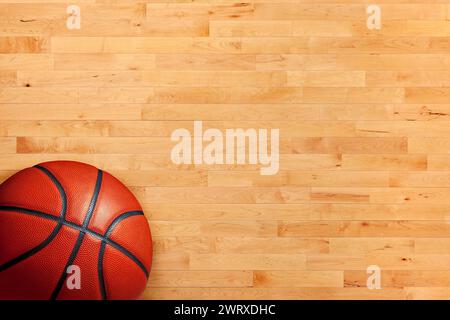 Basketball and hardwood maple basketball court floor viewed from above Stock Photo