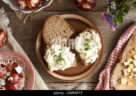 Three slices of sourdough bread with spread made of leftover Easter eggs dyed with onion peels, top view Stock Photo