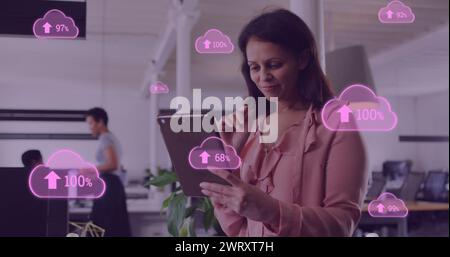 Image of cloud data processing over biracial businesswoman in office Stock Photo
