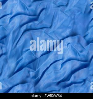 Seamless texture photo of blue colored wrinkled satin drapery material. Stock Photo