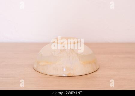 Handmade ceramic bowl, white and beige, wooden. High quality photo Stock Photo