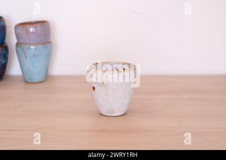 Handmade colourful cup on wooden table. High quality photo Stock Photo