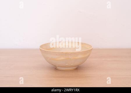 Handmade ceramic bowl, white and beige, wooden. High quality photo Stock Photo