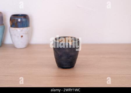 Handmade colourful cup on wooden table. High quality photo Stock Photo