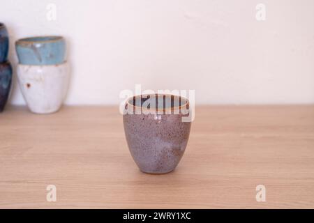 Handmade colourful cup on wooden table. High quality photo Stock Photo