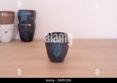 Handmade colourful cup on wooden table. High quality photo Stock Photo