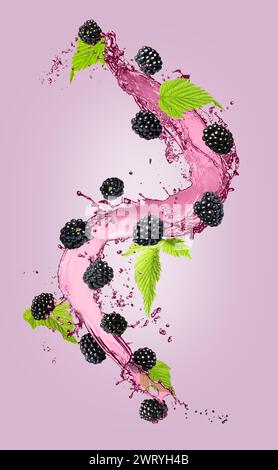 Fresh blackberries and juice in air on violet background Stock Photo