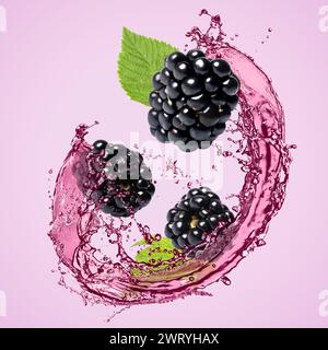 Fresh blackberries and juice in air on violet background Stock Photo