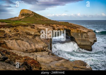 Tunnel Beach  located south of St Clair Dunedin ,  has sea carved sandstone cliffs, rock arches and caves Stock Photo