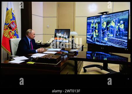 Russian President Vladimir Putin participates via video link with government members in the ceremony of pouring the first concrete into the base of the nuclear island of power unit No. 7 of the Leningrad Nuclear Power Plant. This screenshot taken from a video presented on the Kremlin Press Service website shows Russian President Vladimir Putin participating via video link in an event dedicated to the start of the full-scale implementation of the Moscow-St. Petersburg high-speed railway construction project, and in the ceremony of pouring the first concrete into the base of a nuclear island pow Stock Photo