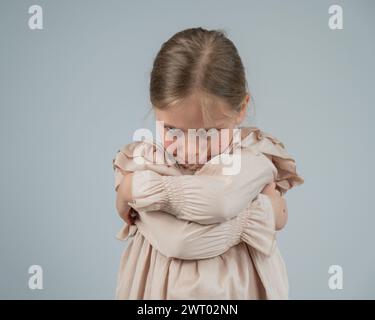 Portrait of a dissatisfied Caucasian girl on a white background.  Stock Photo