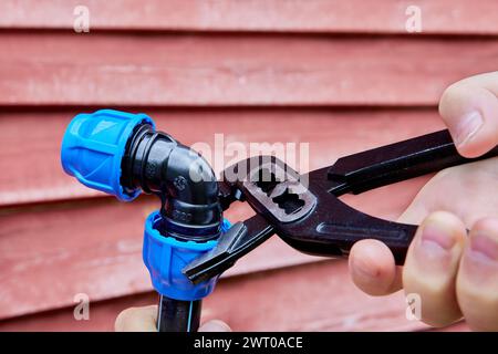 Compression clamping elbow for external water supply Stock Photo