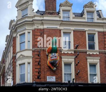 Tsai & Yoshikawa’s The Lion permanent public sculpture mounted on wall of building on Wardour St London is a Chinese symbol of greeting & guardianship Stock Photo