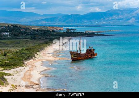 Old shipwreck on a sunny beach with a view of the sea and distant mountains, Dimitrios shipwreck, Glyfada beach, Selinitsa, Gythio, Githio, Gythion Stock Photo