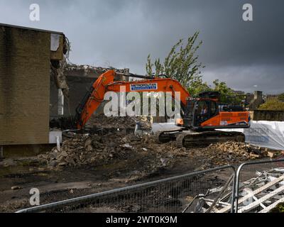 Demolition site (rubble, heavy machinery, building deconstruction, controlled collapse, empty shell) - Baildon library, West Yorkshire, England, UK. Stock Photo