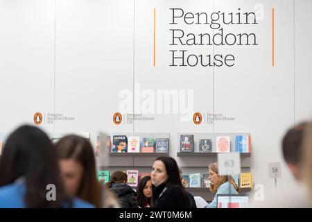 Meetings and book deals on the Penguin Random House book trade stand during the third and final day of the London Book Fair at the Olympia Exhibition Hall, on 14th March 2024, in London, England. The three-day international London Book Fair (LBF) is an annual publishing industry expo and Europe's largest spring book fair that typically attracts 25,000 visitors; exhibitors from across the publishing sector; authors hoping for their book ideas to be commissioned and where international publication rights deals are made for foreign editions. Stock Photo