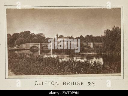 Clifton Bridge &c.. Henry W. Taunt, photographer (British, 1842 - 1922) about 1886 One of two tipped-in photographs illustrating a printed map of Little Wittenham, Dorchester, Warborough, and the surrounding area along the River Thames. The photograph shows a view of Clifton Hampden Bridge from a dirt footpath that runs parallel to the river. The tower and roof of the Church of St. Michael and All Angels is visible over the top of the bridge. (Recto, mount) lower center, below image, printed in black ink: 'CLIFTON BRIDGE &c' Stock Photo