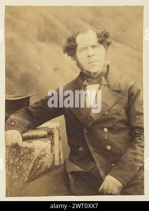 Portrait of a man. Sir John Joscelyn Coghill, photographer (Irish, 1826 - 1905) about 1850s Portrait of a man. He is sitting and resting one arm on a book which is placed on a small table. (Recto, mount) upper right, pencil: '71'; Stock Photo