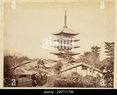 Yasaka-no-to at Hokan-ji Temple. Felice Beato, photographer (English, born Italy, 1832 - 1909) 1850s–1890s View of the five-story pagoda, known as Yasaka-no-to, from the Hokan-ji Temple towering over smaller buildings. A man walks down a dirt road in the foreground that runs through the village towards the pagoda. Stock Photo