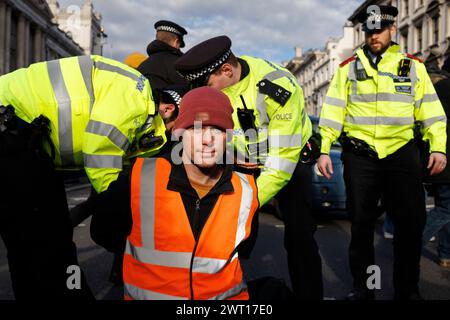 24th Nov 2023. Whitehall, London, UK. Arrests of Just Stop Oil protesters. The protestors were carried off the road within one minute of stepping off the pavement. Stock Photo