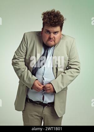 Portrait, plus size and man with stomach in shirt for suit, professional and annoyed with clothes for work. Employee, male person and guy with unhappy Stock Photo