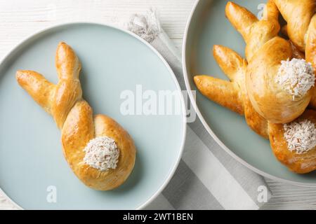 Bunny twist Buns are made with a sweet cinnamon bread dough closeup on the plate on the table. Horizontal top view from above Stock Photo
